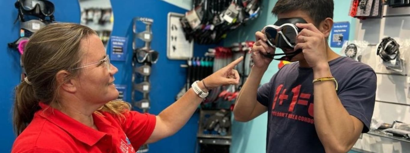 Diver checking mask fit in-store