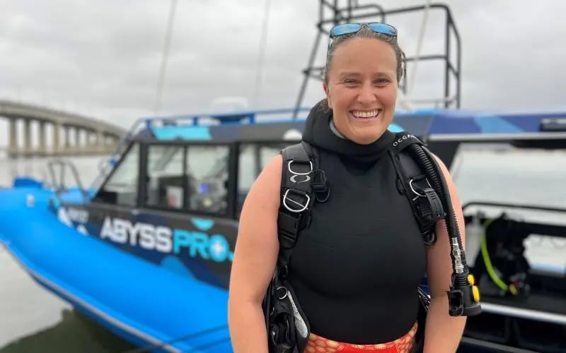 Smiling Sydney diver beside the Abyss dive boat