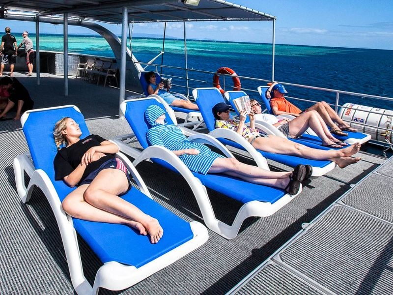 Divers relaxing on the top deck of a liveaboard