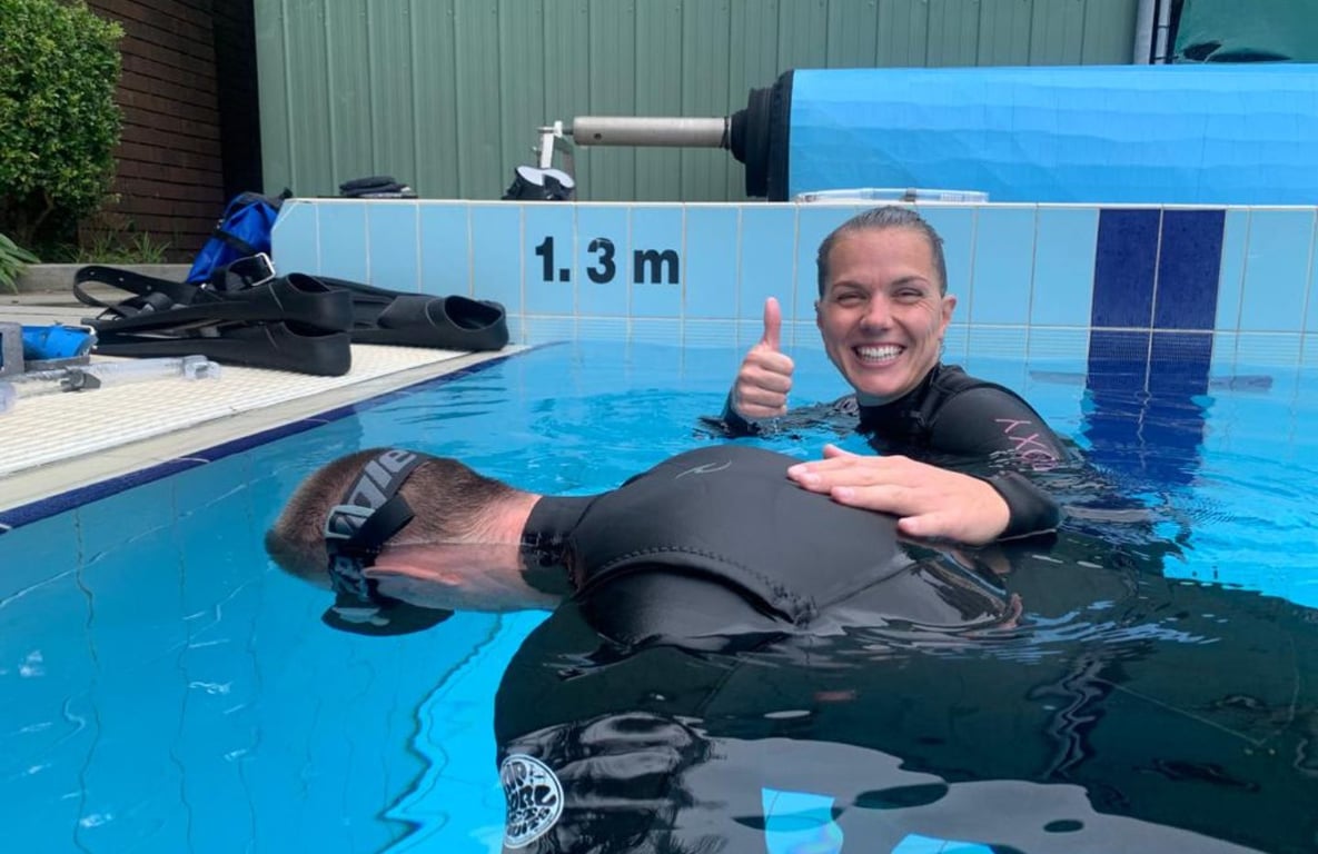 Freedivers students engaged  in breath-hold training in a swimming pool
