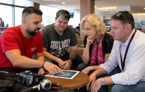 An Abyss trip leader helping divers review a dive travel plan