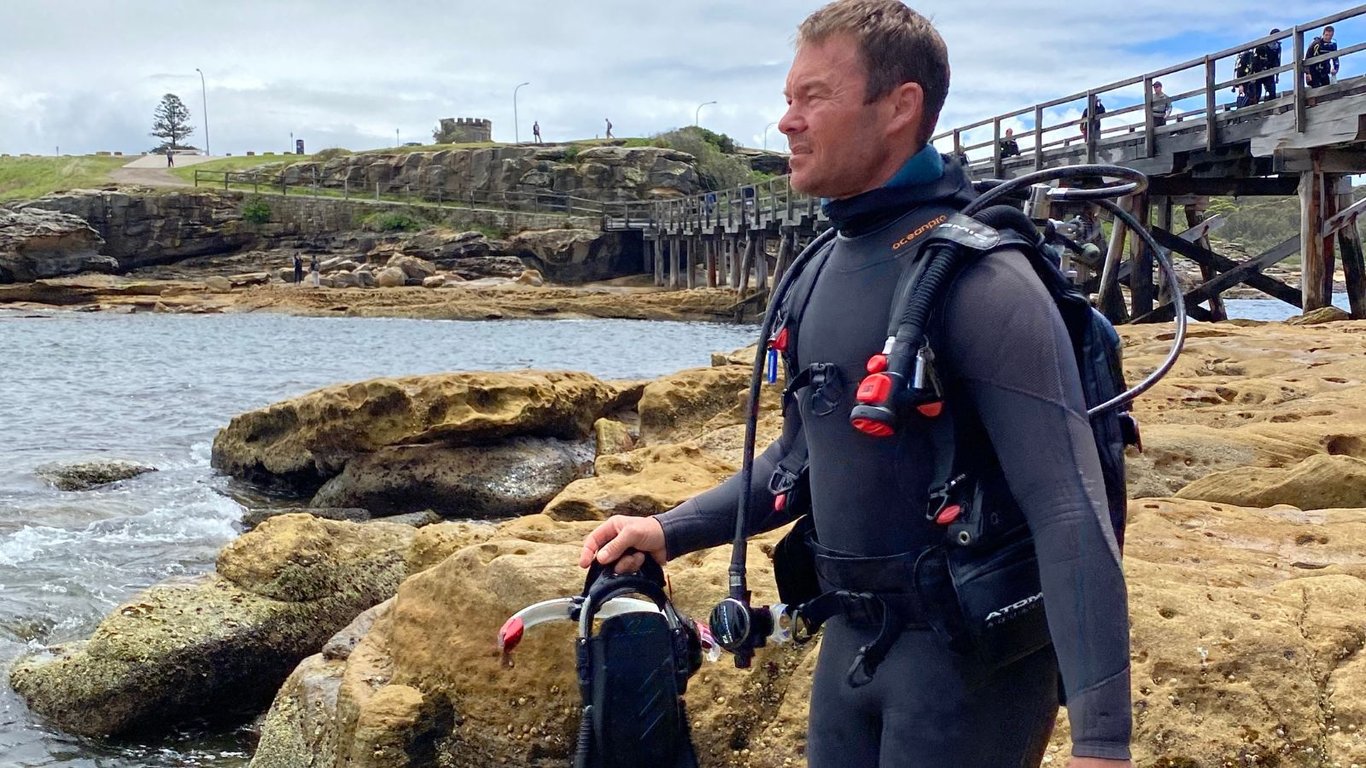 A divemaster checks out the water at Bare Island before leading a goup of divers in for a guided dive