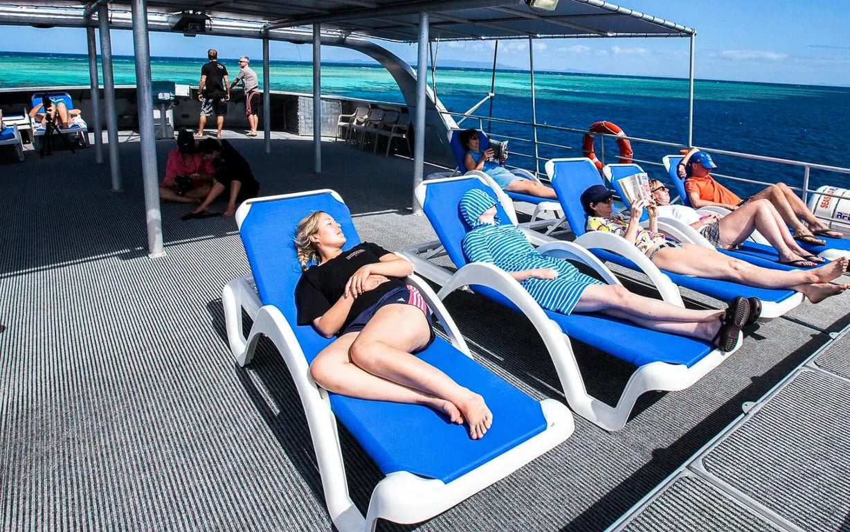 Divers relaxing on a liveaboard between dives