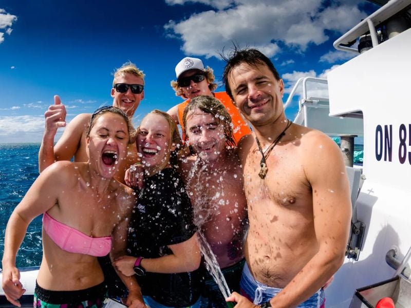 Smiling divers having fun on board