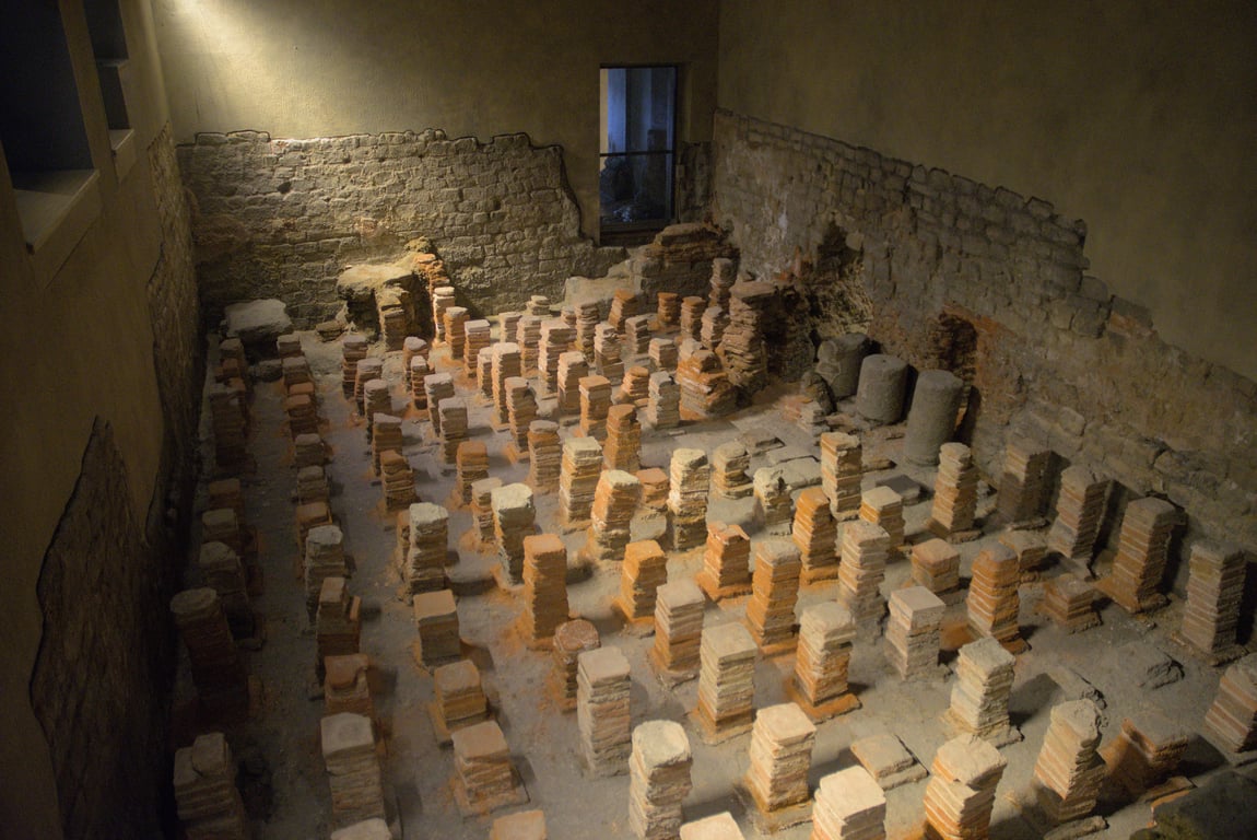 A room with stacks of bricks spaced evenly in a square pattern