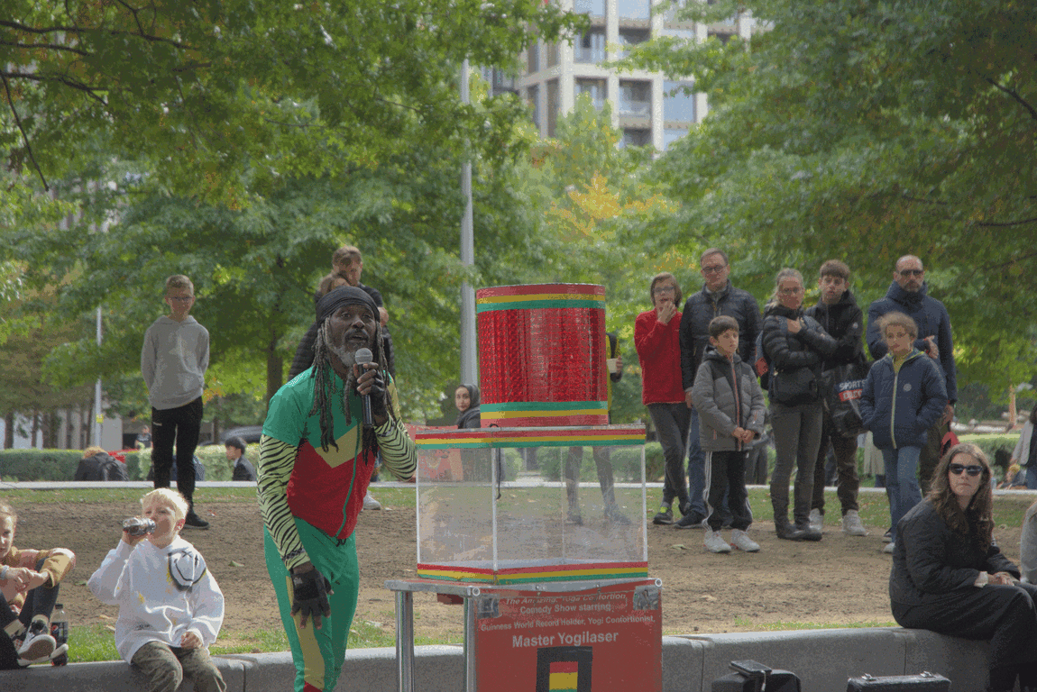 Master Yogilaser contorting himself through a small tube and into an acrylic box.