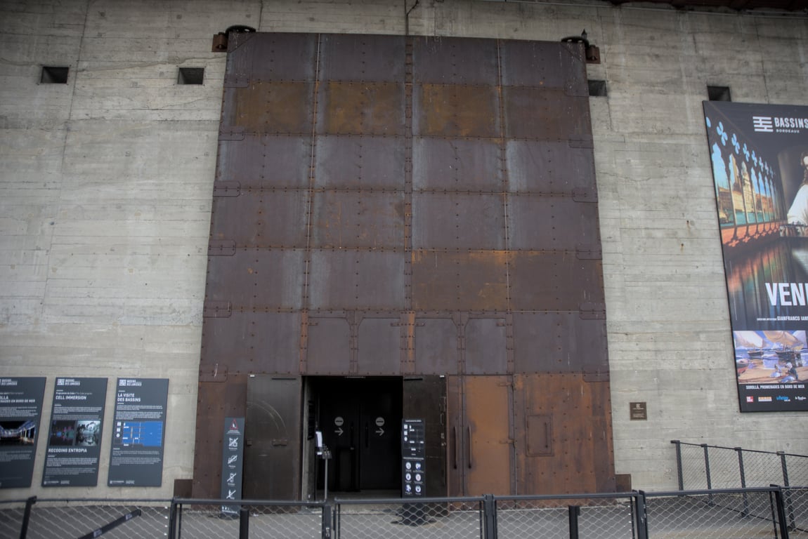 A set of heavy steel doors, at least 8 meters high