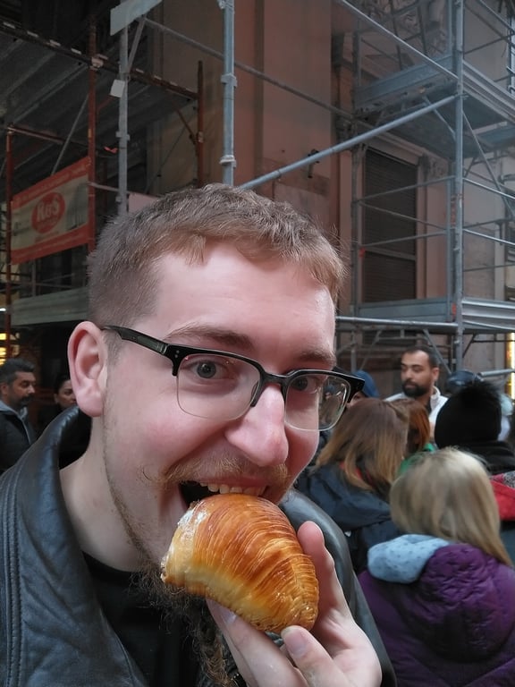 Me taking a bite out of a sfogliatella riccia