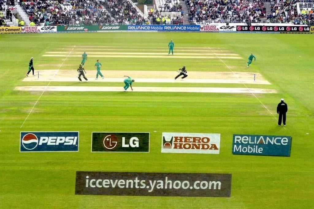 Traditional Marketing Advertisement on the ground grass surface of a cricket stadium