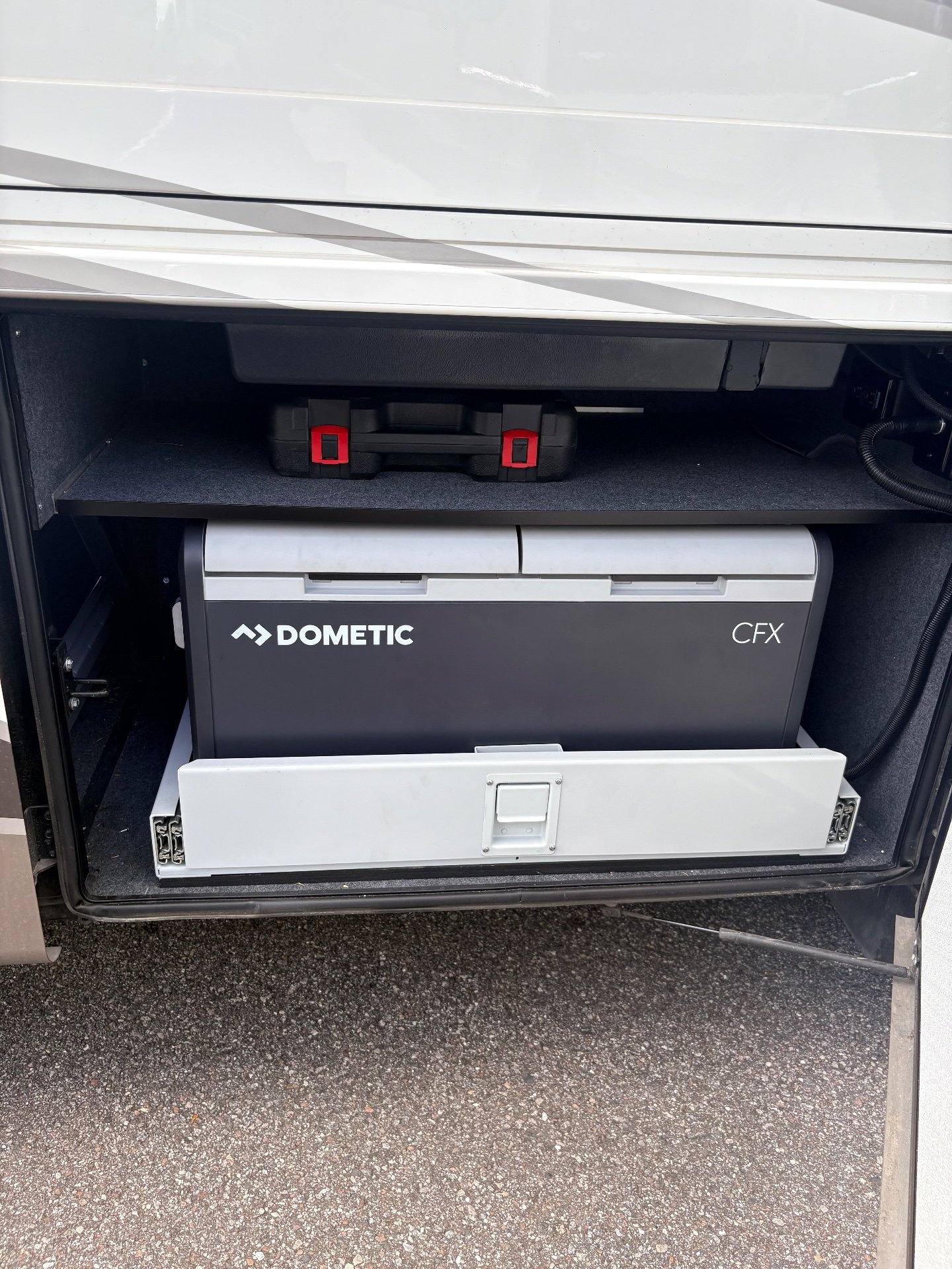 2025 Newmar Dutch Star 4369 — Open exterior compartment visibly contains a Dometic CFX unit and equipment
