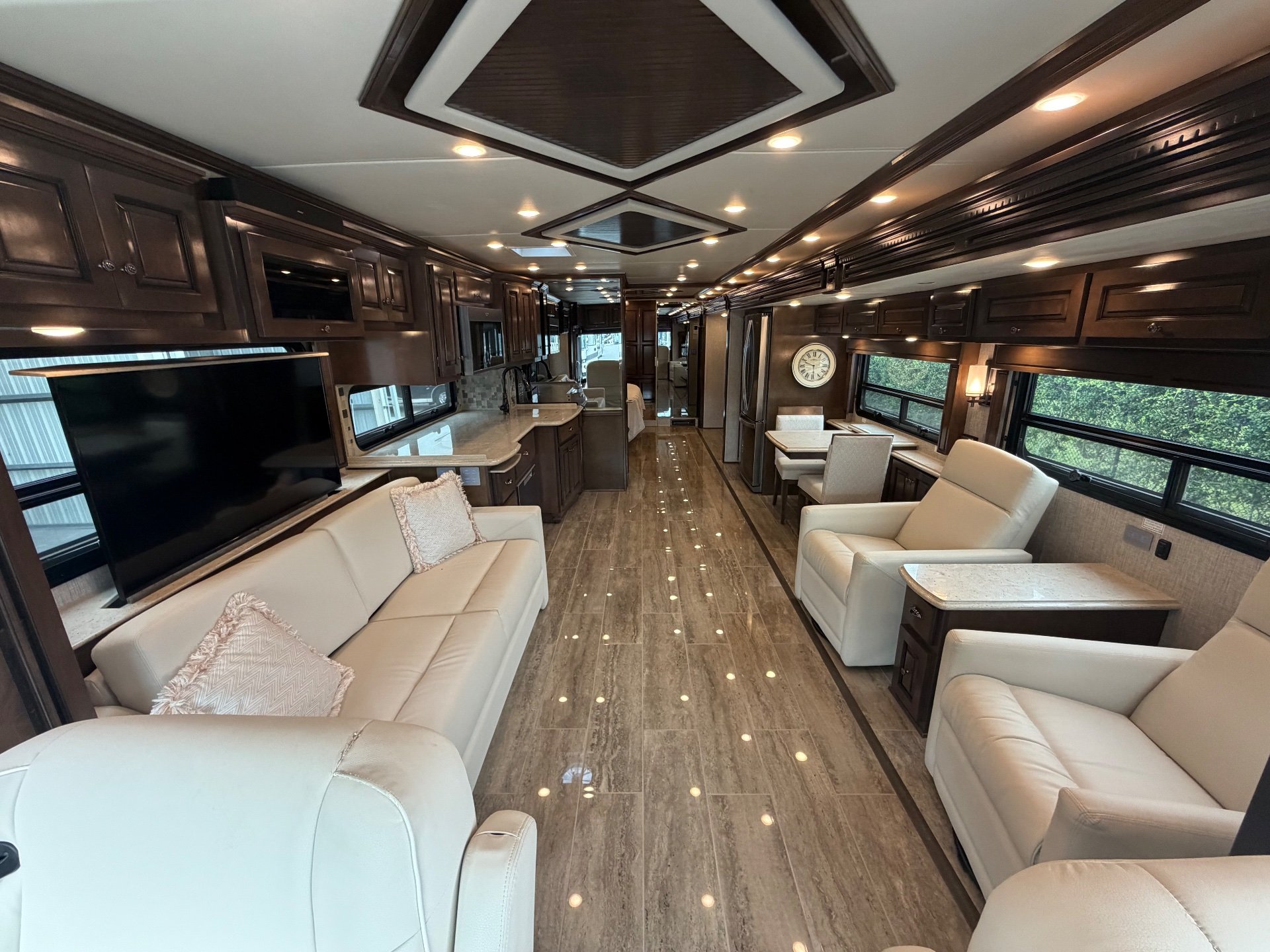 2021 Newmar Dutch Star 4369 — Class A motorhome interior overview with sofas, recliners, dinette, kitchen counters, cabinetry, and a long central aisle