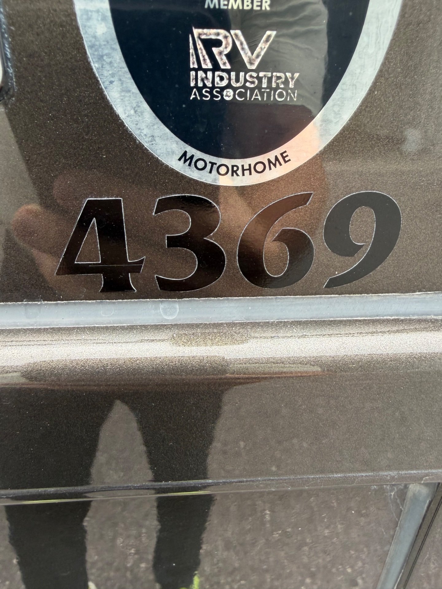 2021 Newmar Dutch Star 4369 — Close-up photograph of the motorhome exterior showing the 4369 model marking and RV Industry Association emblem