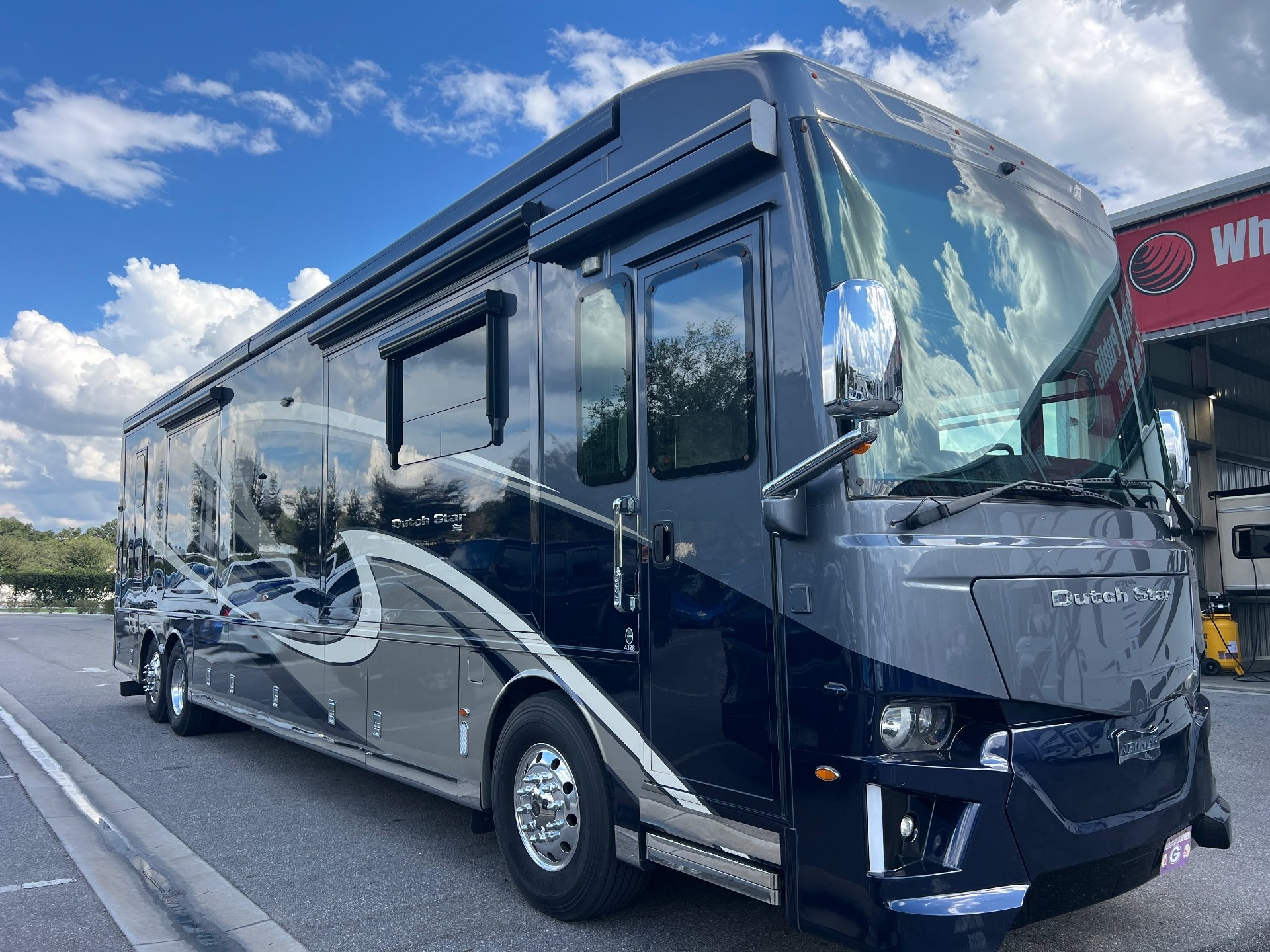2020 Newmar Dutch Star 4328 — Full exterior three-quarter photograph of the Dutch Star motorhome, showing its front, side, wheels, windows, and awnings