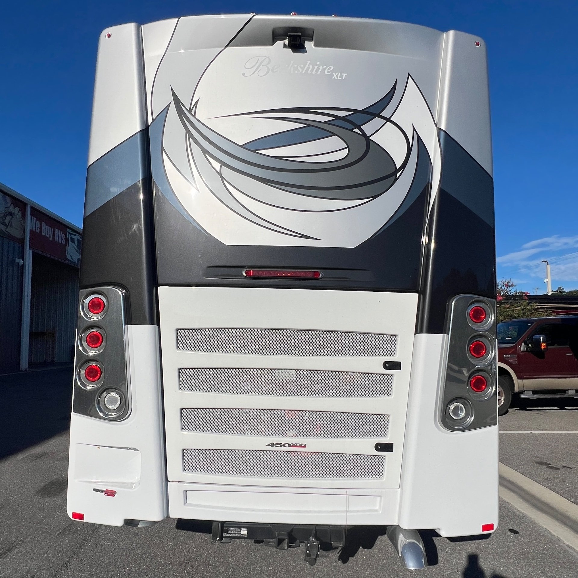 2024 Forest River Berkshire XLT 45CA — Rear exterior photograph visibly shows engine ventilation grilles, tail lights, hitch, and exhaust components