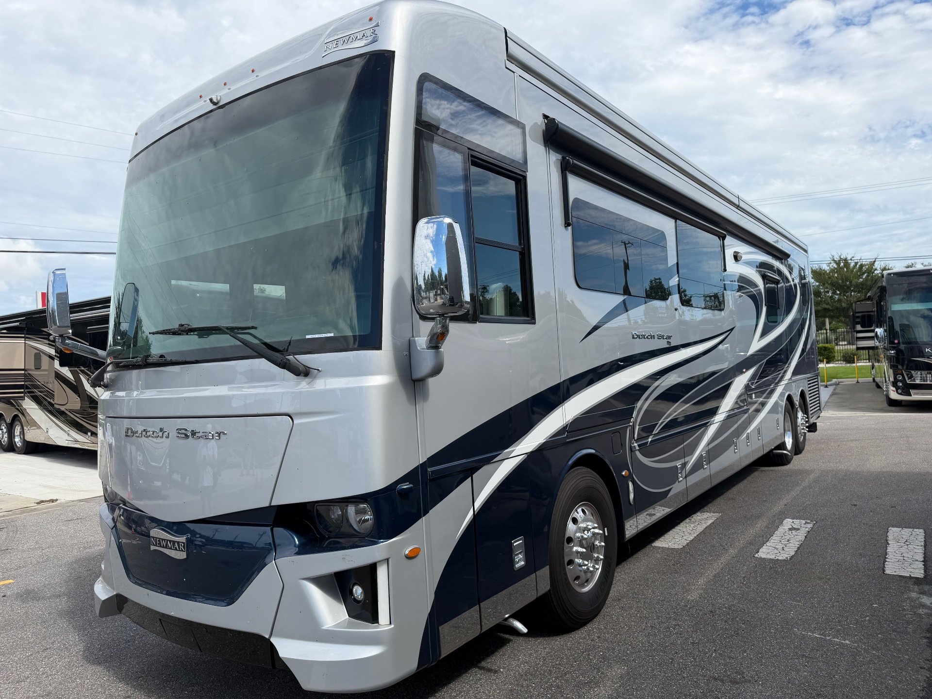 2022 Newmar Dutch Star 4369 — Photograph clearly shows the front and side exterior of the motorhome, including body graphics, windows, and wheel