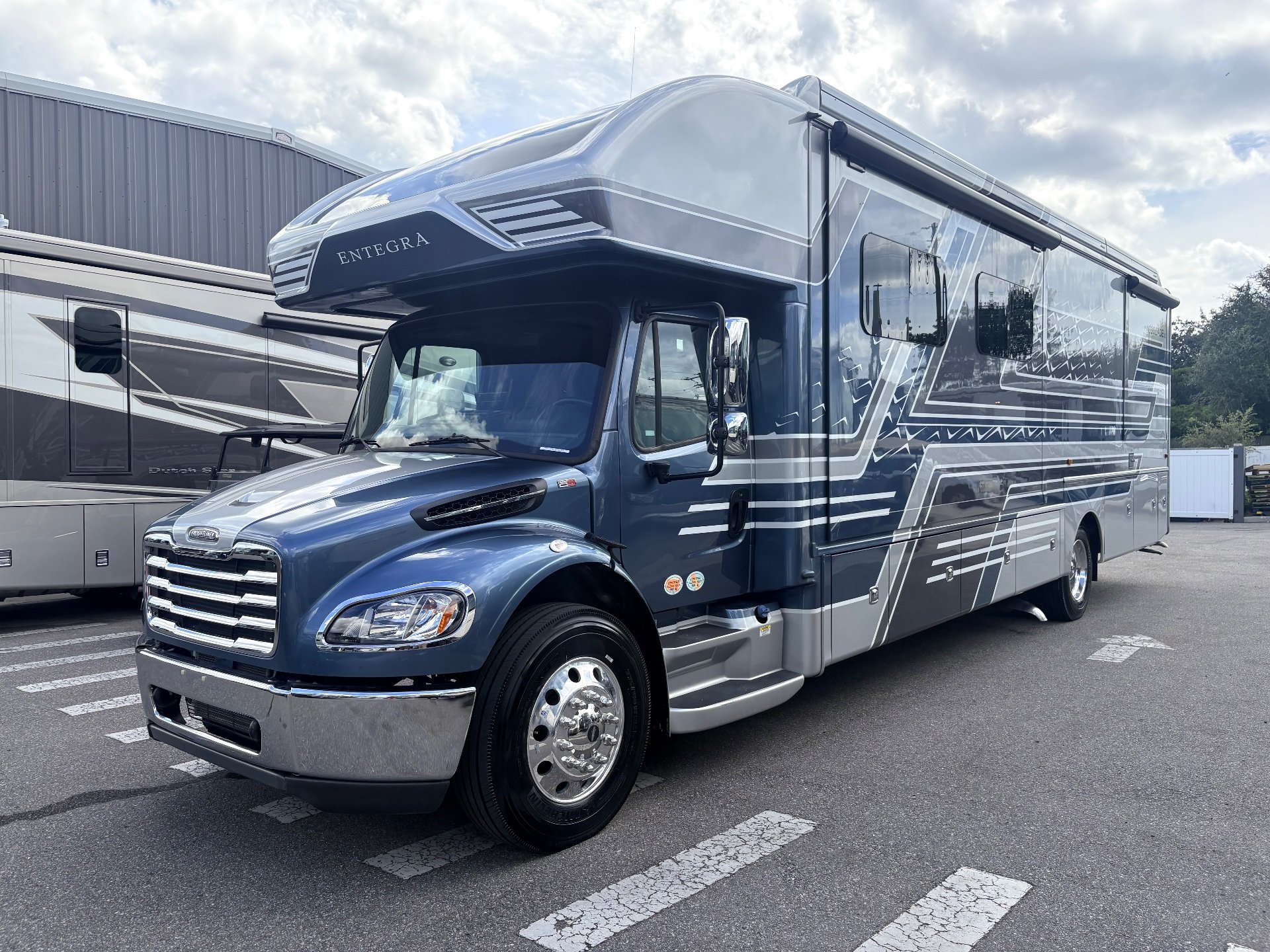 2025 Entegra Coach Accolade XL 37L — Clearly shows the motorhome’s exterior front, cab, side wall, windows, graphics, and wheel