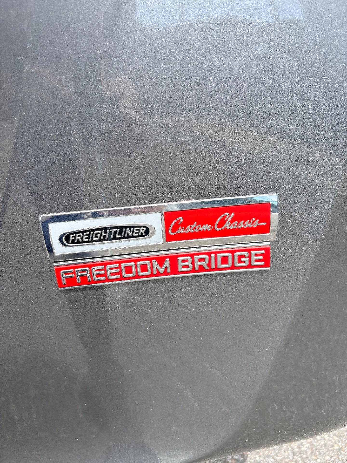 2024 Fleetwood Discovery LXE 40M — Visible badge mounted on the RV's exterior body panel