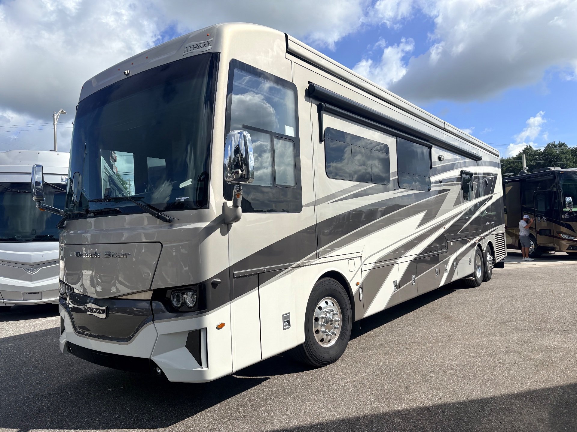 2025 Newmar Dutch Star 4369 — The RV's exterior front and passenger side, including windows, awnings, wheels, and body panels