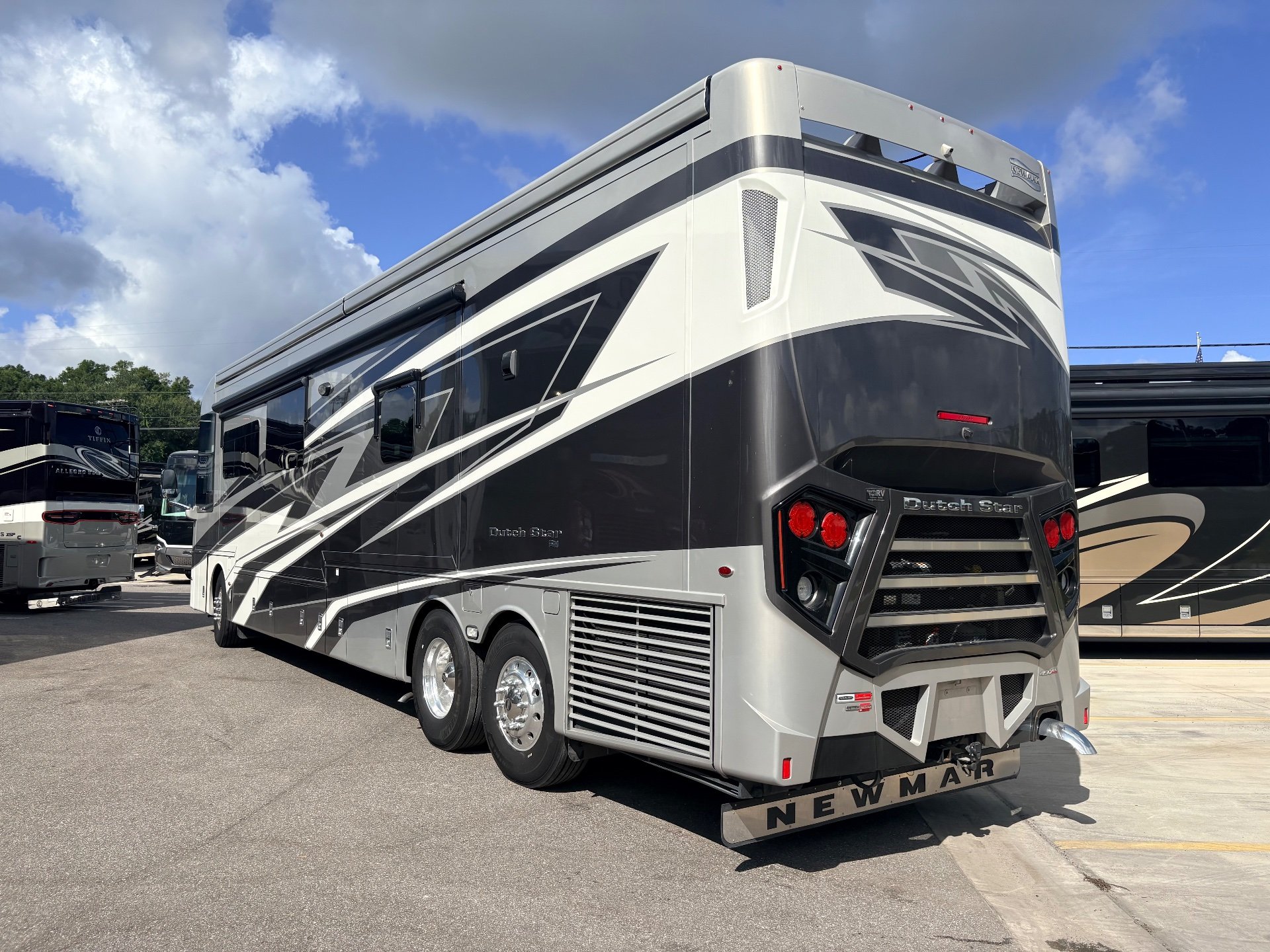 2025 Newmar Dutch Star 4369 — Rear three-quarter photograph visibly shows the motorhome exterior, rear body, wheels, vents, and storage panels