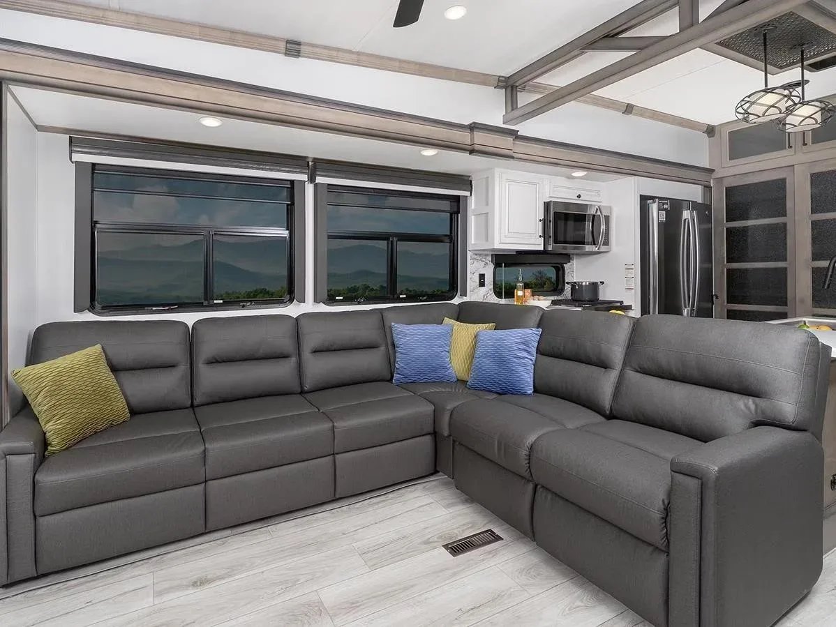 Fifth wheel trailer with L-shaped sectional couch