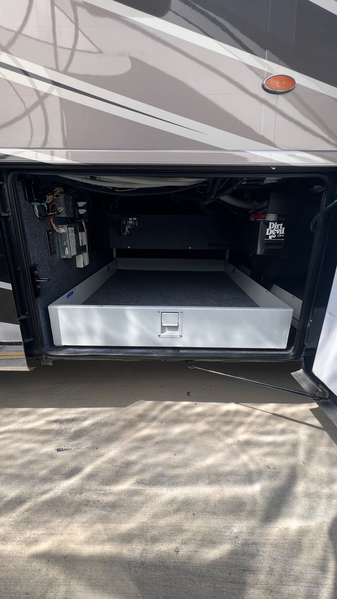 2018 Newmar Dutch Star 4369 — Open exterior cargo compartment with a drawer and wiring visible; this is a storage-focused exterior feature