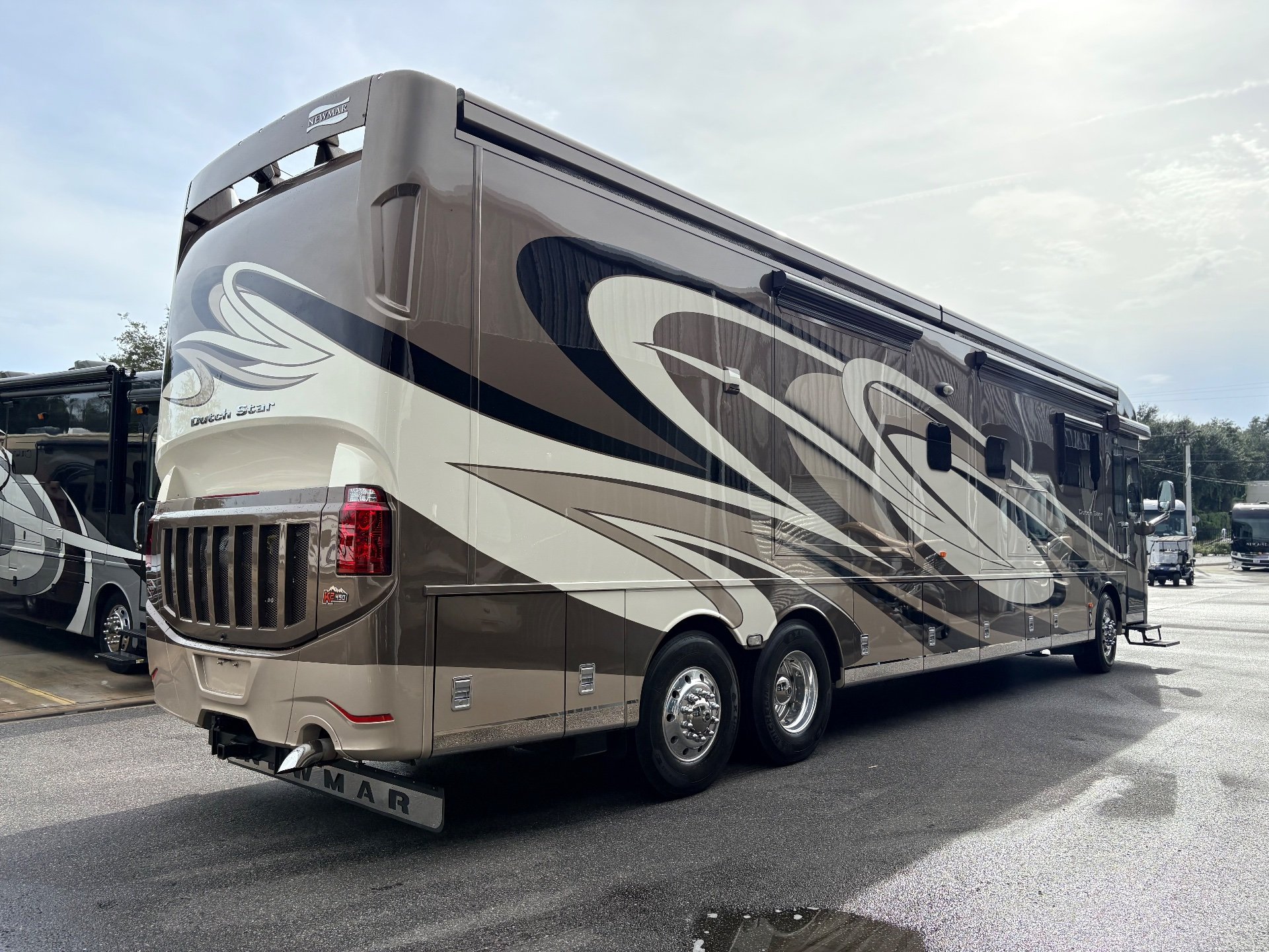 2017 Newmar Dutch Star 4369 — Photograph clearly shows the rear-side exterior shell, graphics, wheels, compartments, and bumper