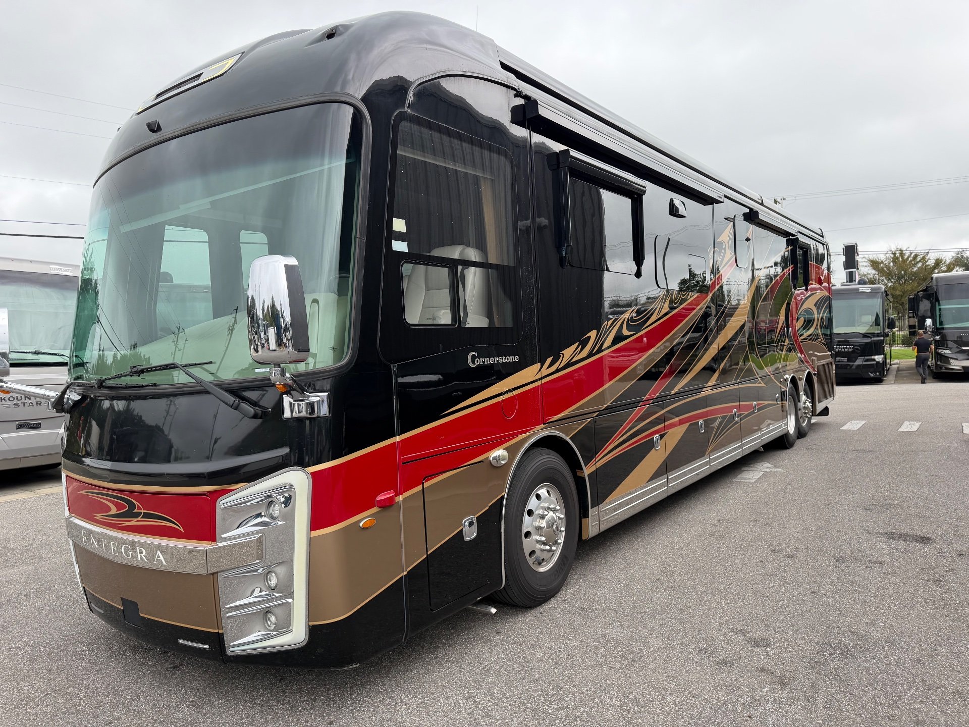 2021 Entegra Coach Cornerstone 45F — The front and opposite side exterior of the motorhome