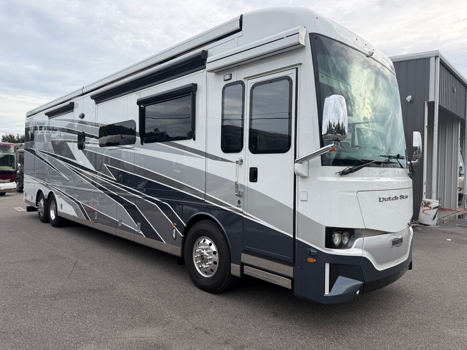 2025 Newmar Dutch Star 4369 — Visible full exterior three-quarter view of the Dutch Star motorhome, including body, windows, wheels, and awnings