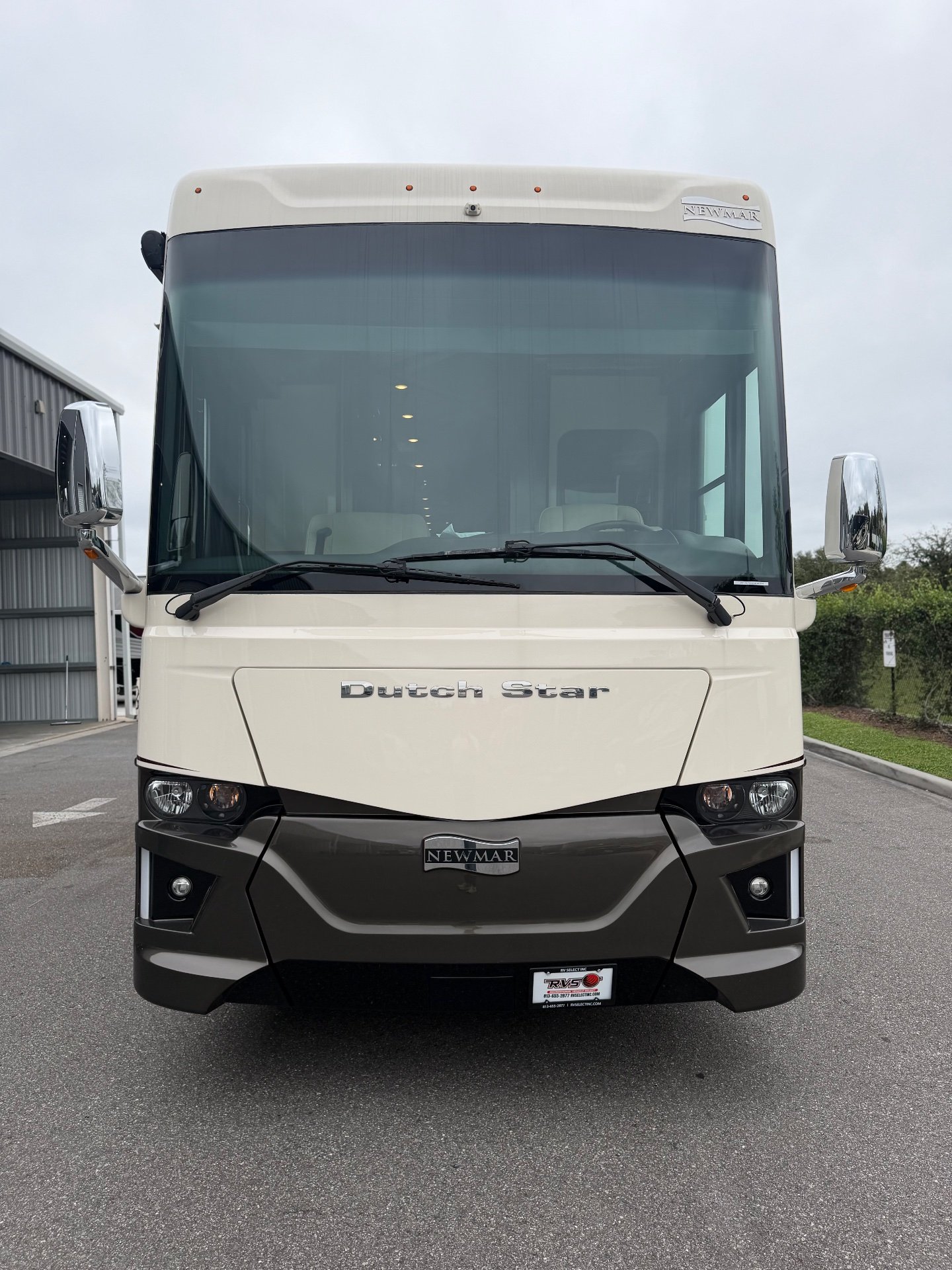 2021 Newmar Dutch Star 4369 — Straight-on photograph of the motorhome's exterior front, windshield, grille, lights, and body