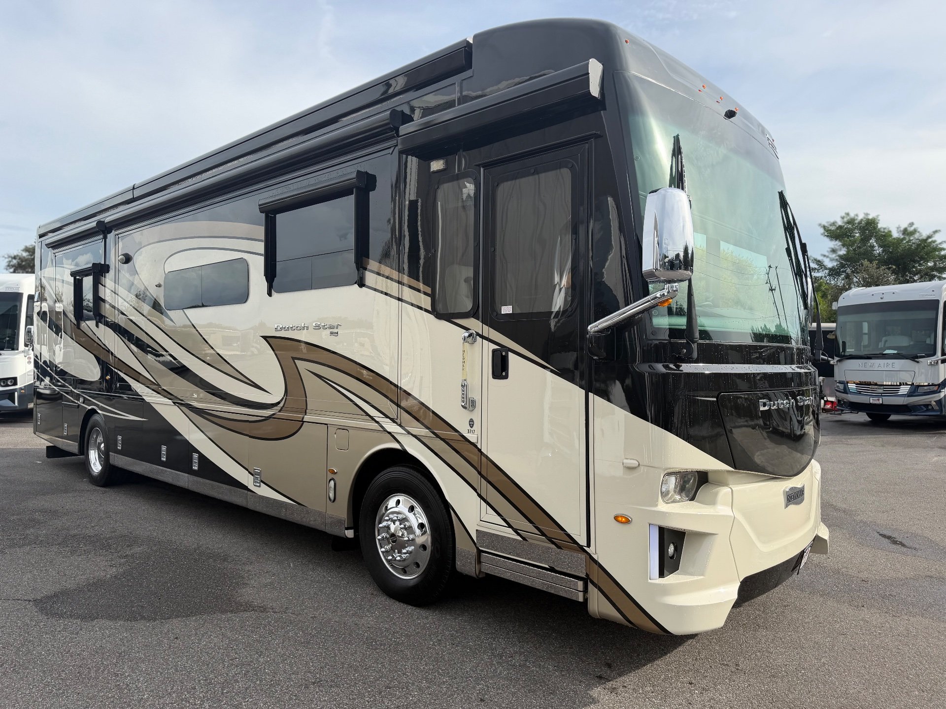 2020 Newmar Dutch Star 3717 — The front and side exterior shell of a Dutch Star motorhome, including bodywork, windows, wheel, and awnings