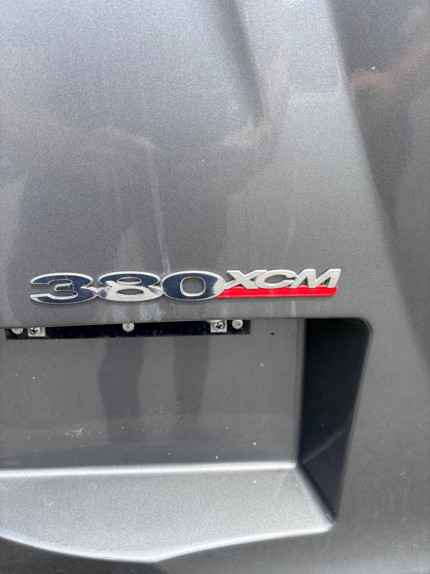 2024 Fleetwood Discovery LXE 40M — Close-up photograph visibly shows an exterior body badge reading 380 XCM; it is an exterior detail without a more specific listed function