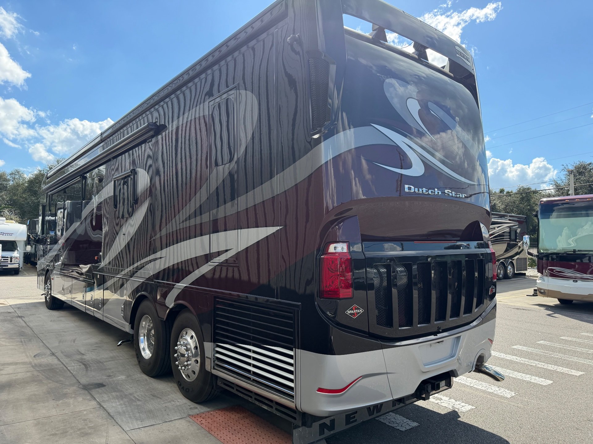 2017 Newmar Dutch Star 4369 — The rear and side exterior of the motorhome, including rear cap, taillights, vents, wheels, and hitch