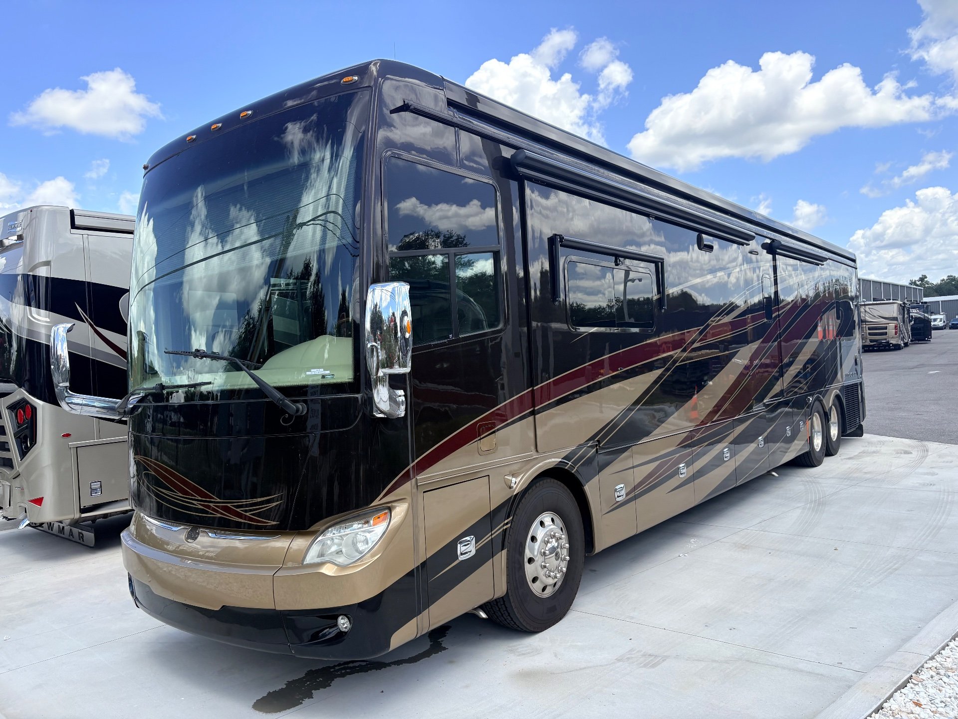 2017 Tiffin Allegro Bus 45 OPP — Photograph clearly shows the motorhome's front and side exterior, including exterior graphics, windows, wheels, and compartments