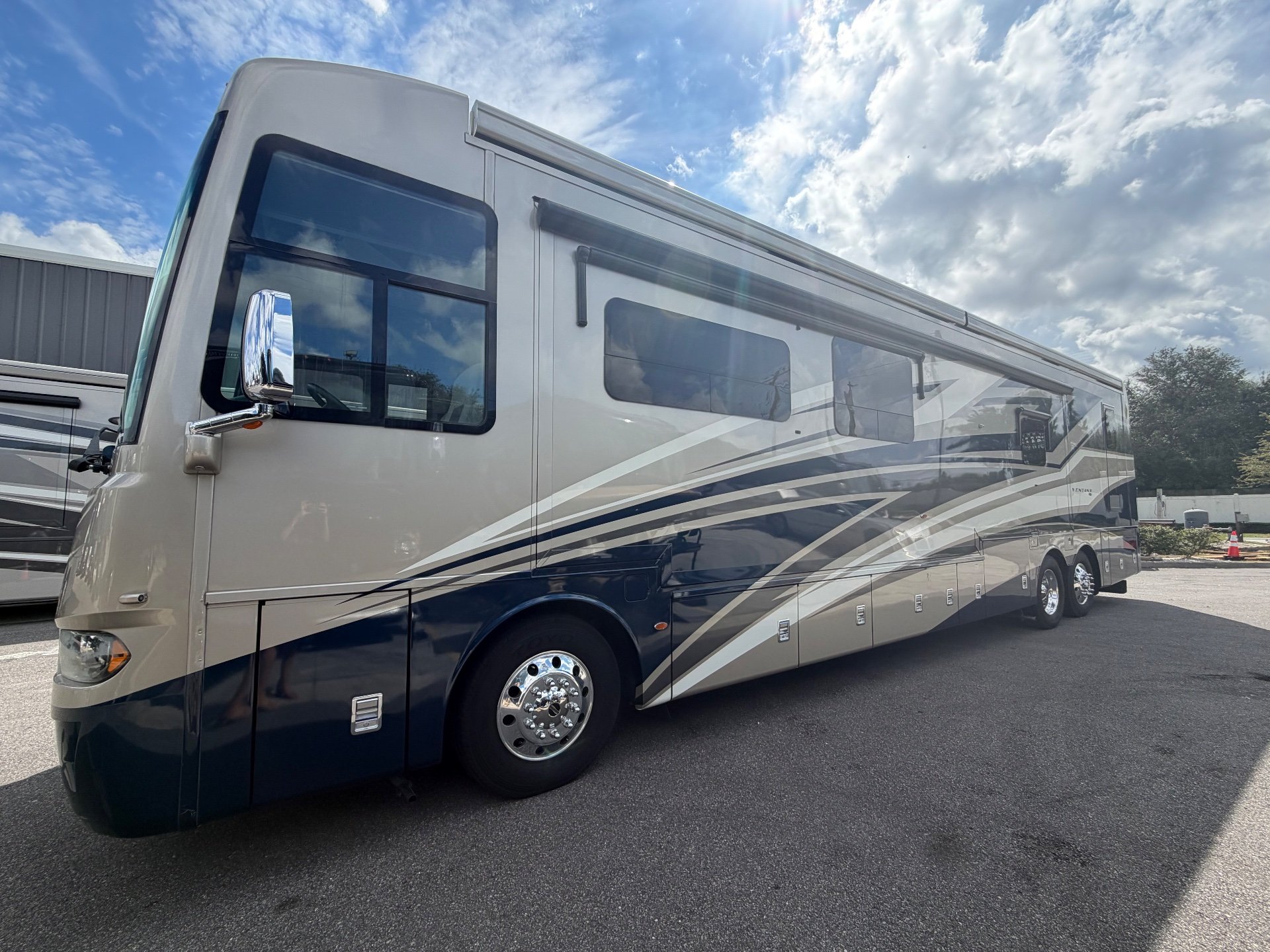 2020 Newmar Ventana 4369 — Angled exterior photograph visibly shows the motorhome side, front corner, windows, wheel, and body graphics