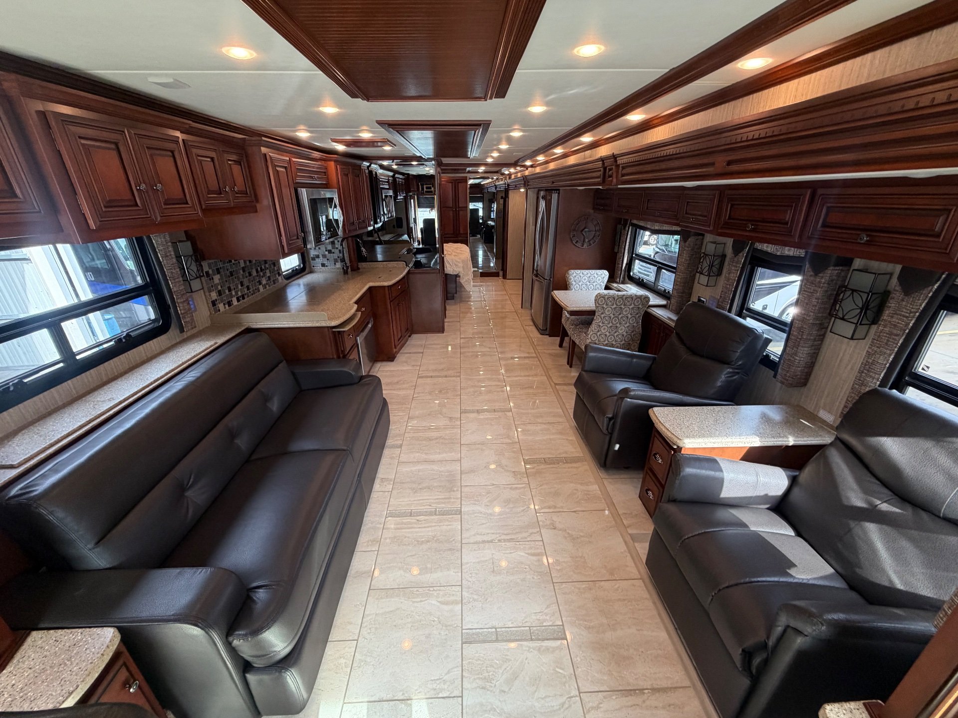 2017 Newmar Dutch Star 4369 — Class A motorhome interior overview with sofas, recliners, dinette, kitchen counters, cabinetry, and a central tiled aisle
