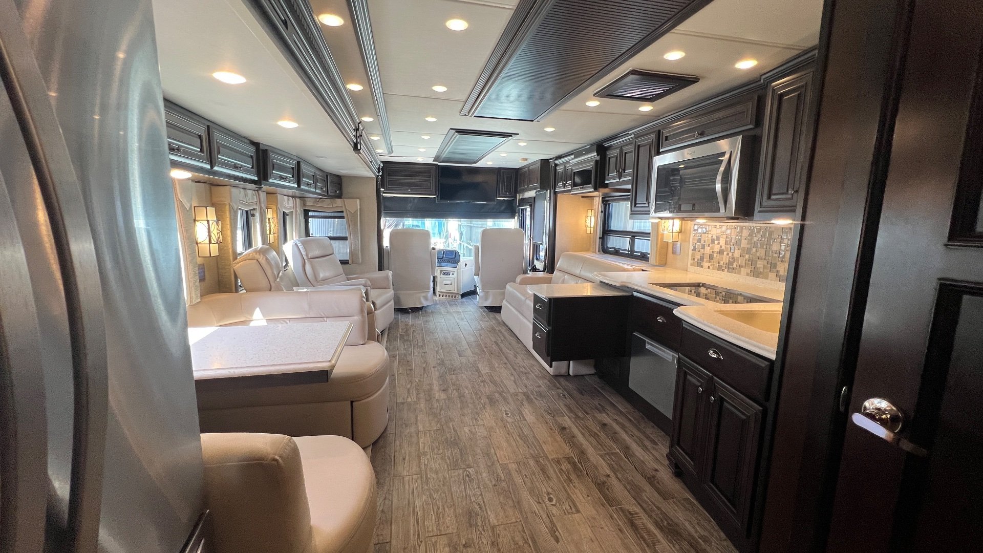 2018 Newmar Dutch Star 4369 — Class A interior overview with lounge seating, kitchen counters and appliances, and driver cockpit visible at the front