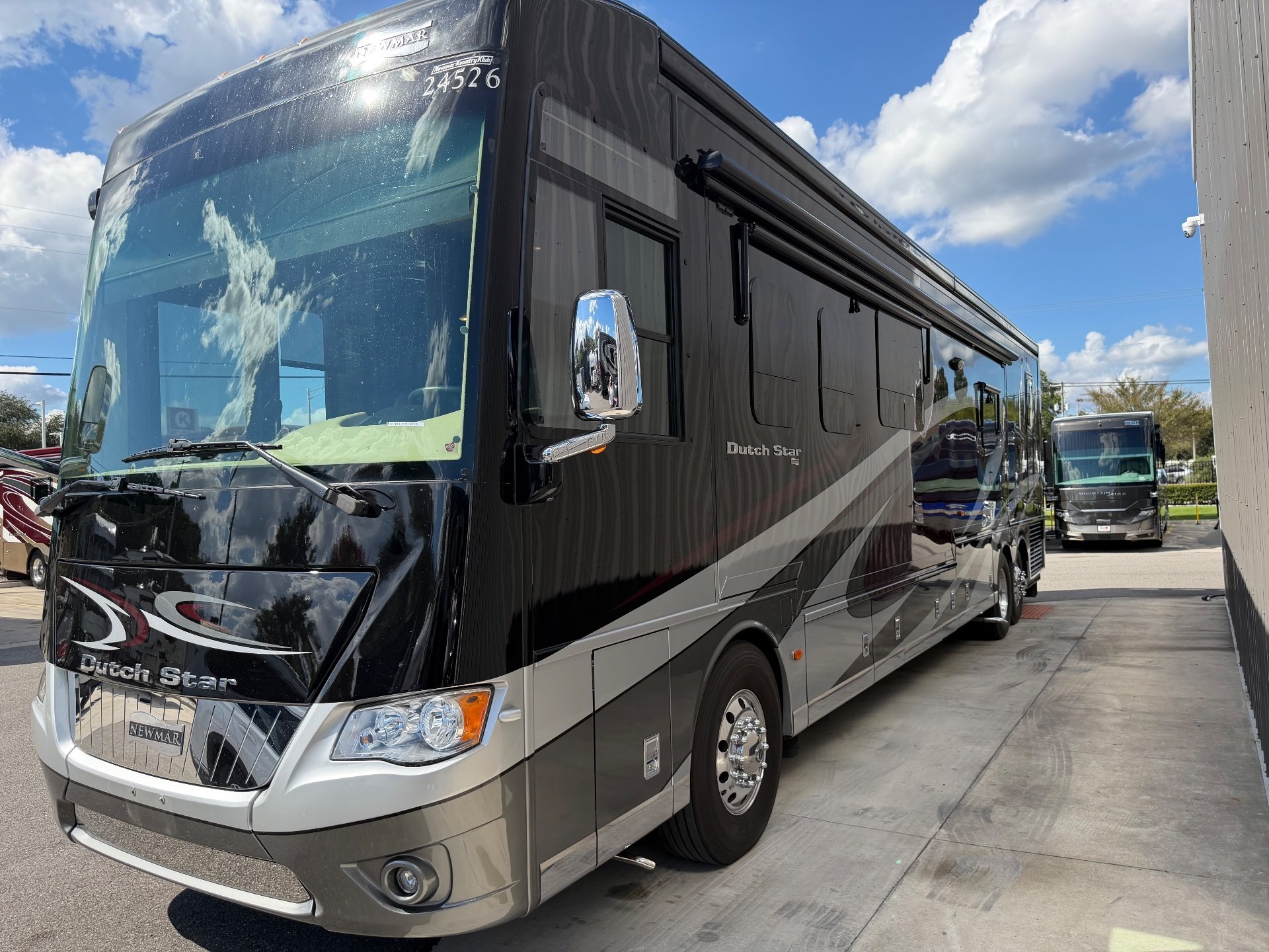 2017 Newmar Dutch Star 4369 — The front and passenger-side exterior of the motorhome, with body panels, windows, awnings, and wheel