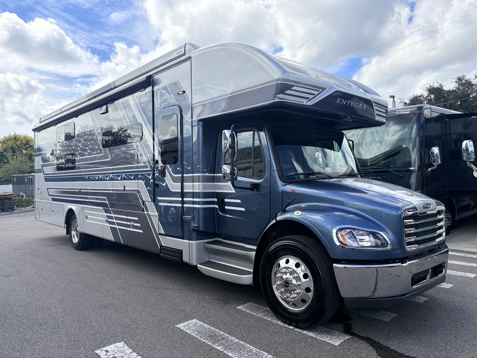 2025 Entegra Coach Accolade XL 37L — Clearly shows the exterior front and side of the Entegra motorhome, including body, cab, wheel, and awning