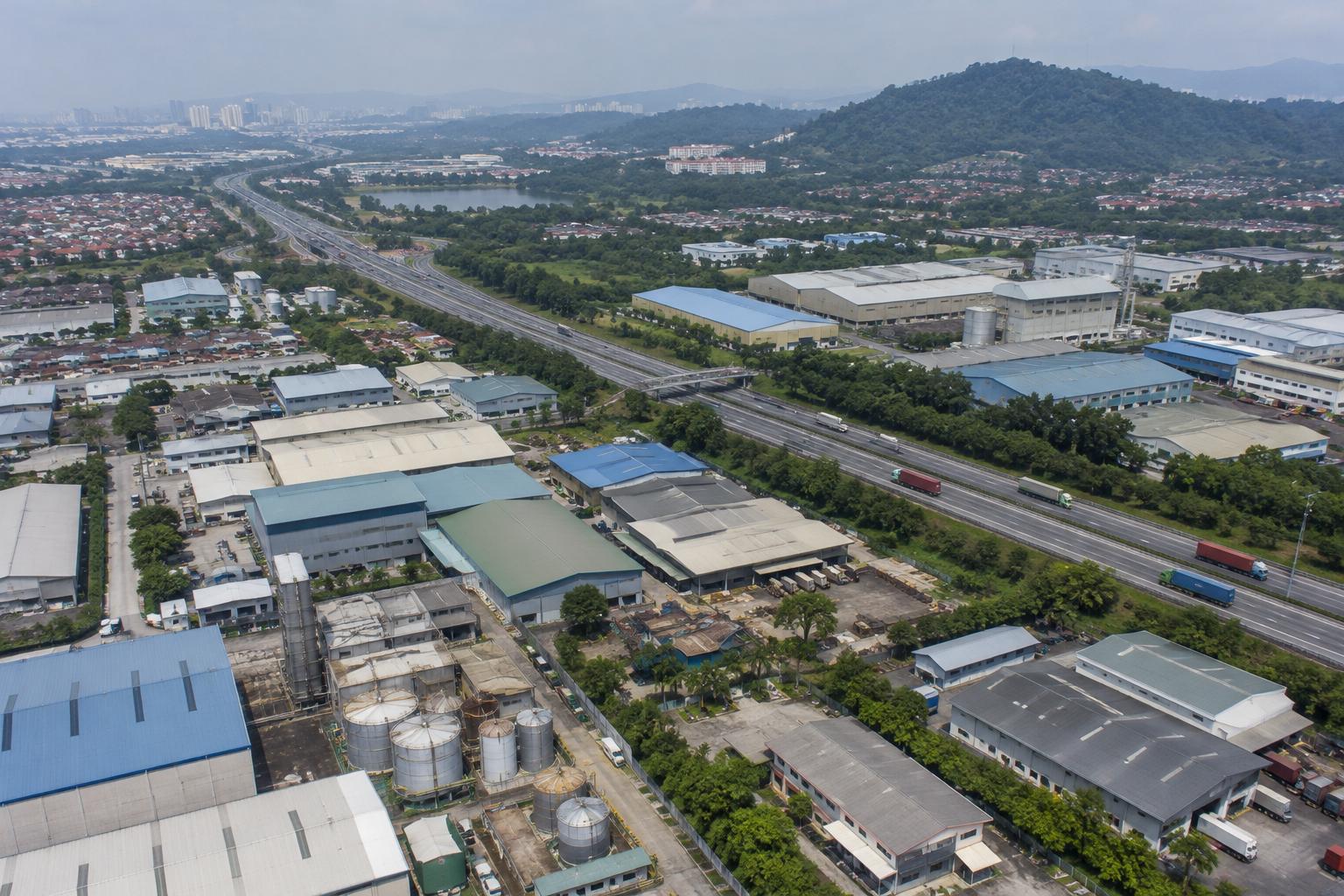 Aerial view of an industrial district in the Klang Valley with a highway