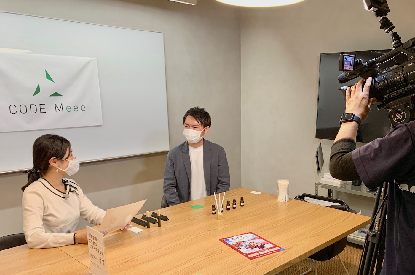 Photo of Kenji being interviewed