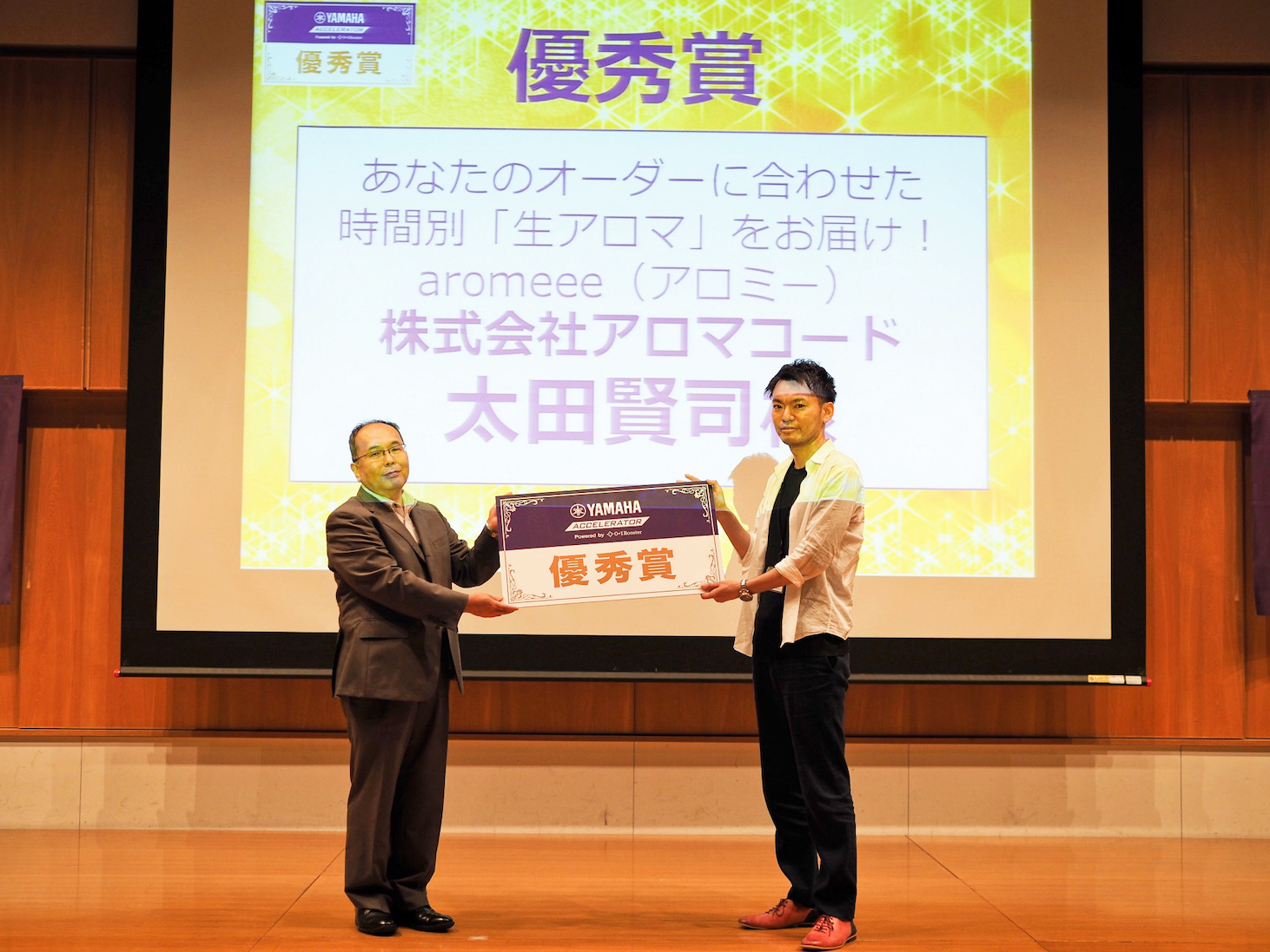 Photo of Kenji receiving the Excellence Award