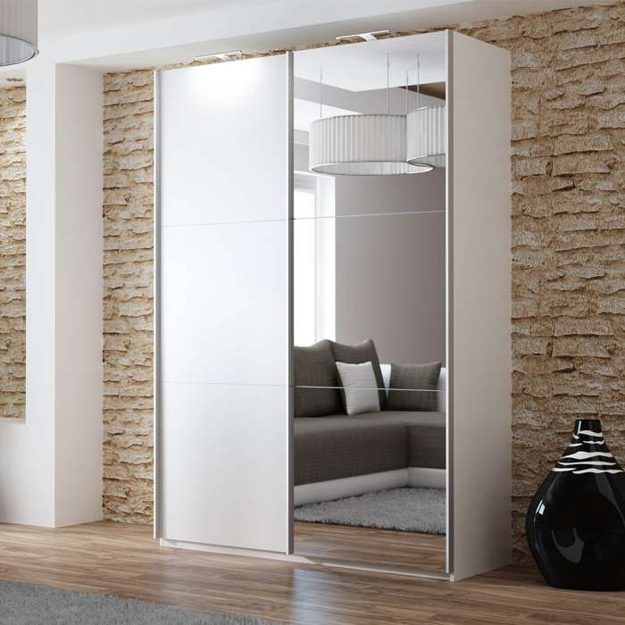 The sliding door wardrobe VIGO 150cm white with mirrored door and LED lights in a room.