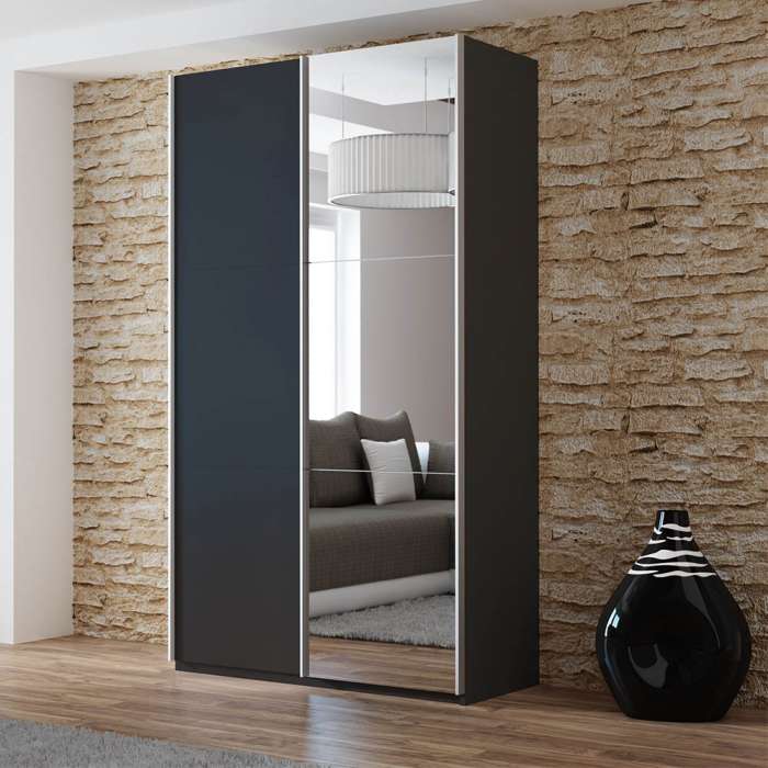 The sliding door wardrobe VIGO 120cm black with mirrored door in a room.