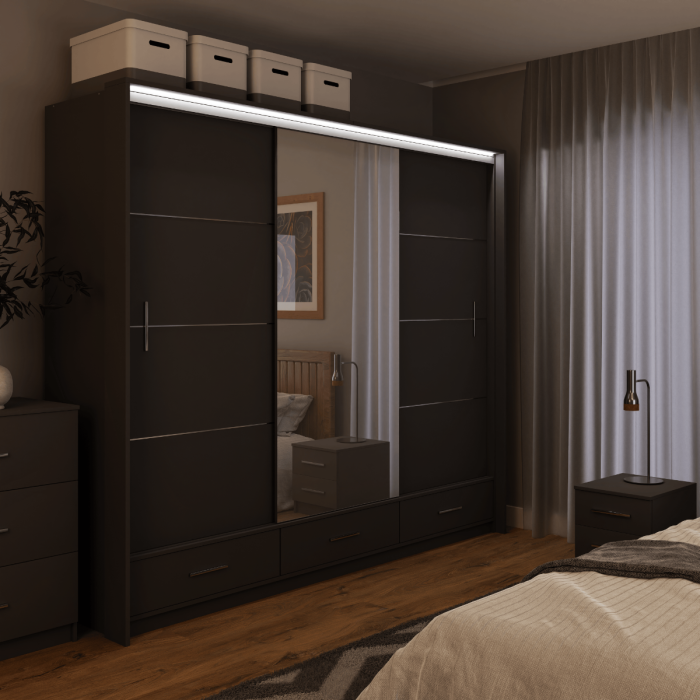 The sliding door wardrobe MARSYLIA 255cm graphite with mirrored door with LED lighting in a bedroom.