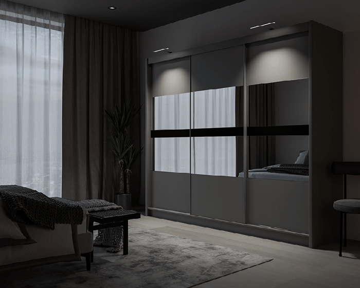 The sliding door BATUMI 250cm graphite displaying the LED in a cosy bedroom.