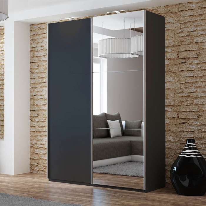 The sliding door wardrobe VIGO 150cm black with mirrored door and LED lights in a room.