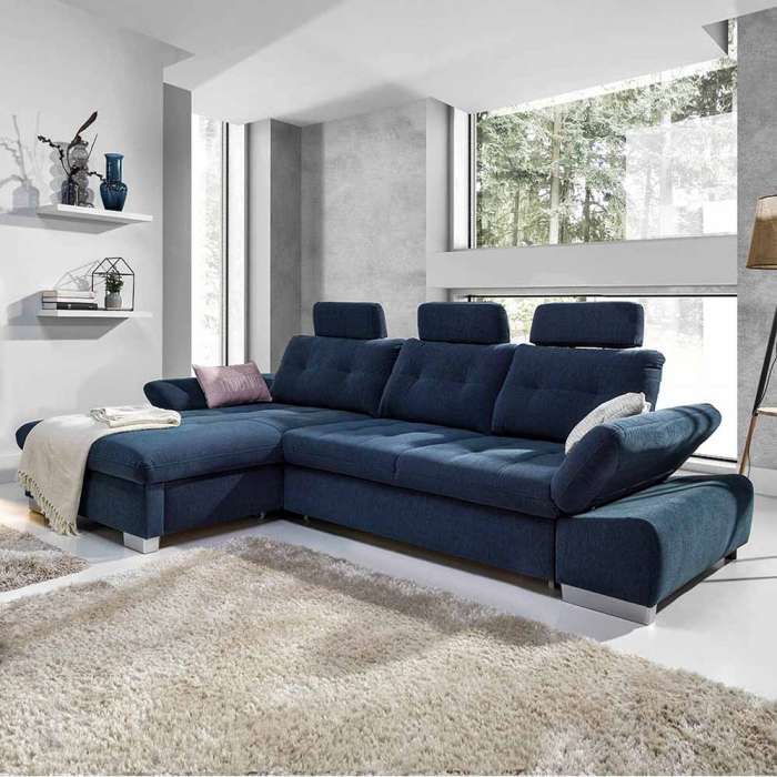 Corner sofa bed CALAMO 2 in a cosy living room showing adjustable armrest