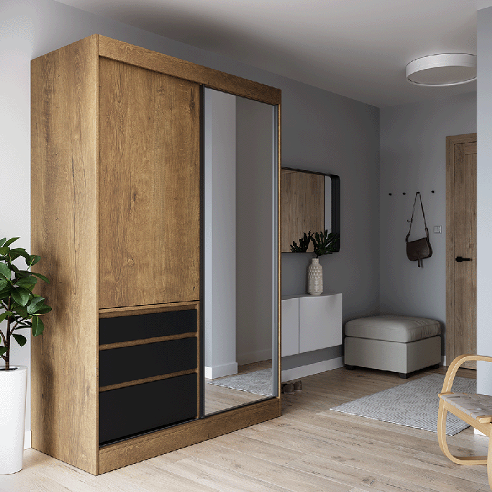 The sliding door wardrobe HAIDAR oak / black with mirrored door in a cosy bedroom.