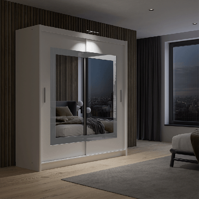 The sliding door wardrobe PRESTON 203cm white displaying a single LED in a cosy bedroom.