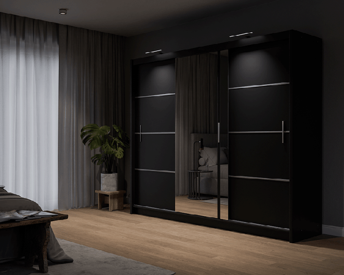 The sliding door VISTA 250cm black displaying the LED in a cosy bedroom.